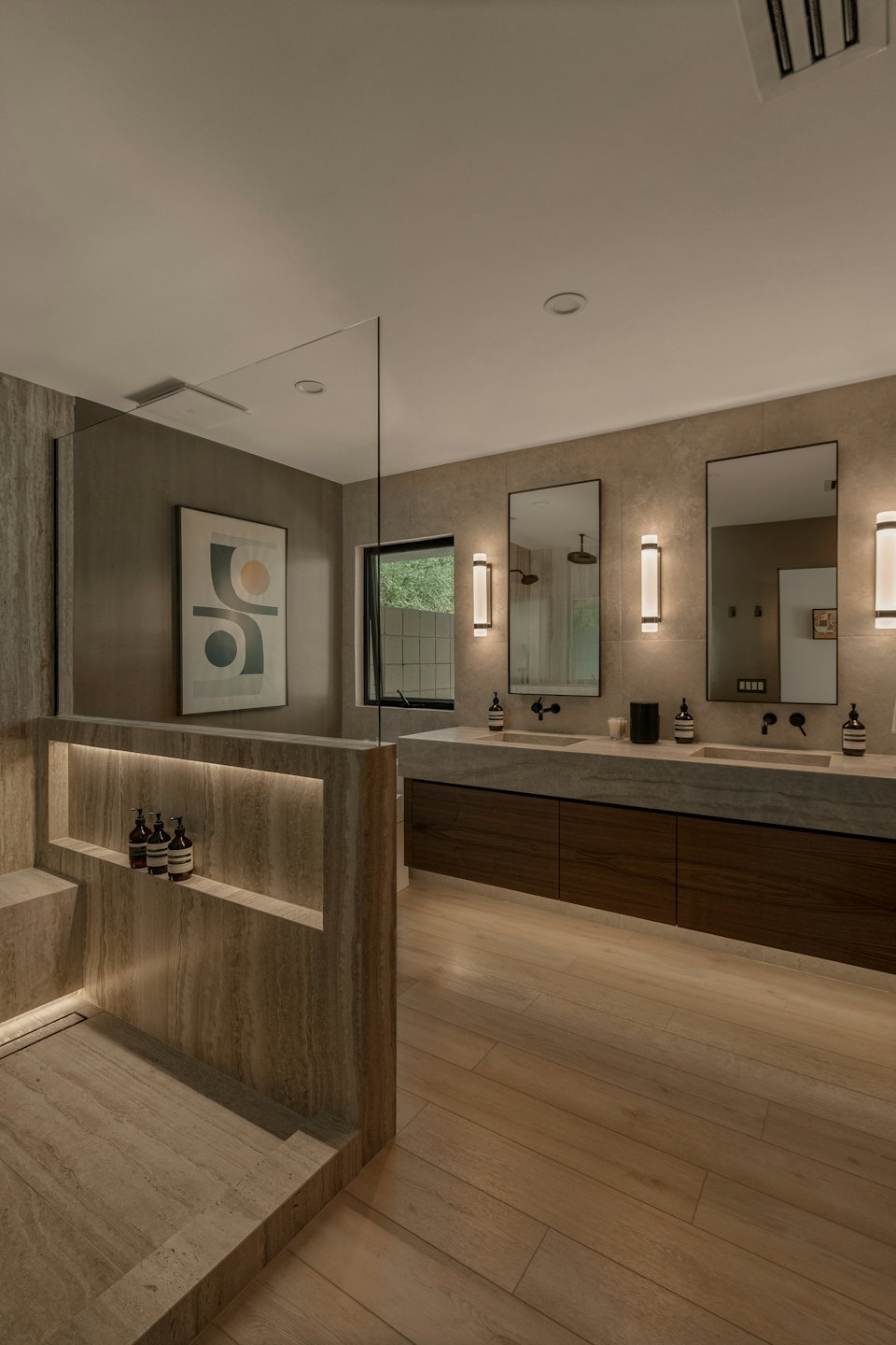 Modern bathroom with a stone shower and wooden vanity.